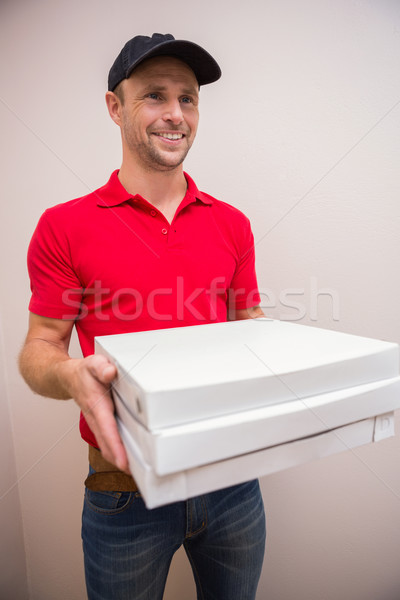 Portrait of happy delivery man holding pizza Stock photo © wavebreak_media