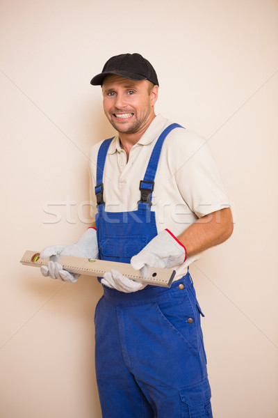 Confused construction worker holding spirit level Stock photo © wavebreak_media
