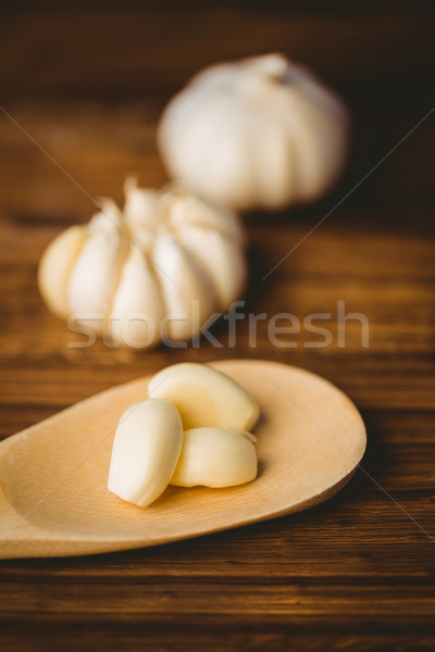 Garlic cloves and bulb on chopping board Stock photo © wavebreak_media