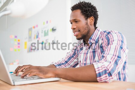 Stock photo: Concentrated casual businessman working with computer