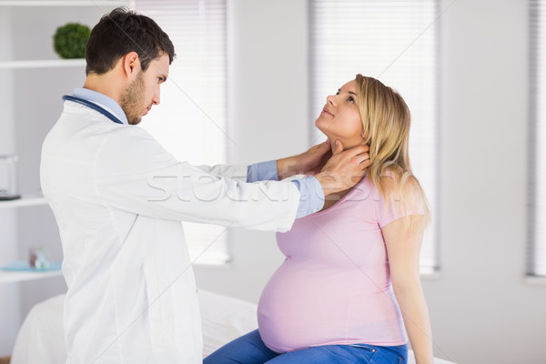 Doctor examining neck of pregnant patient Stock photo © wavebreak_media