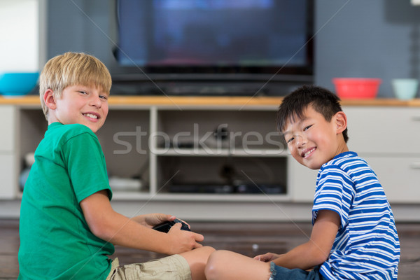 Two brothers playing video games at home. - a Royalty Free Stock Photo from  Photocase