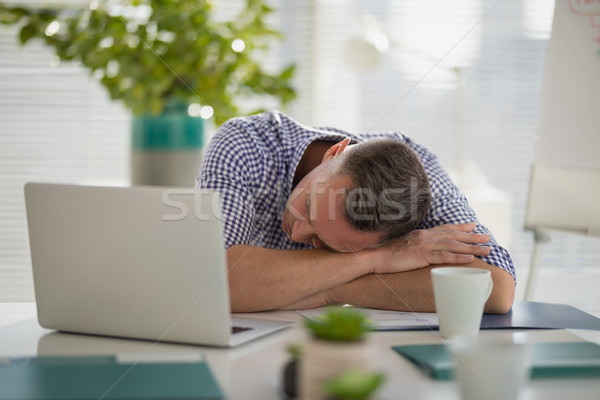 Tired Executive Sleeping At Desk Stock Photo C Wavebreak Media Ltd