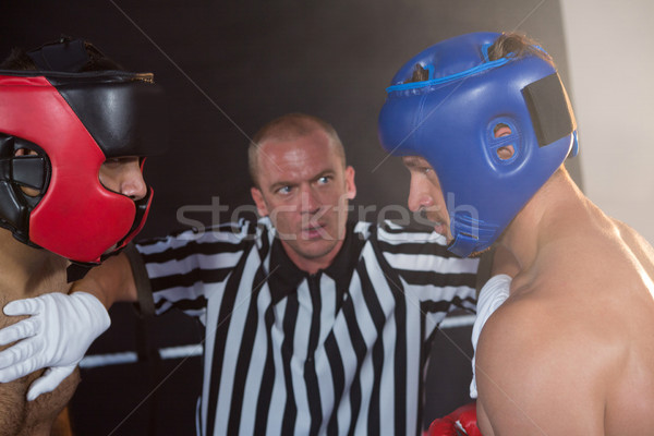 Referee stopping aggressive male boxers Stock photo © wavebreak_media