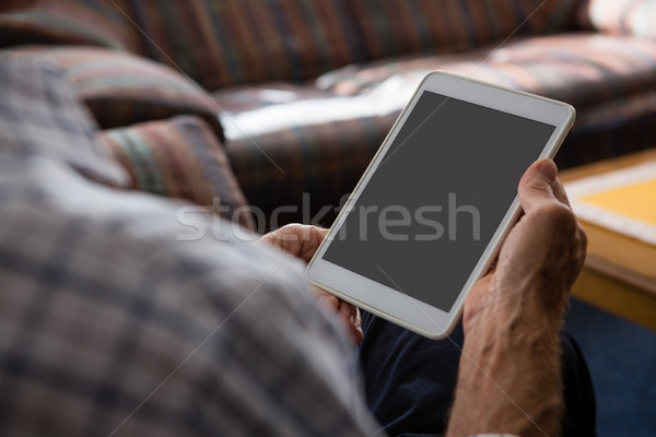 Hands of senior man using tablet computer while sitting in nursing home Stock photo © wavebreak_media