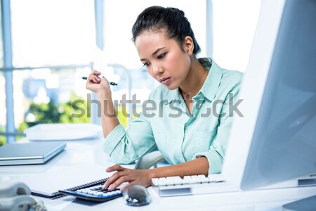 Serious businesswoman searching files Stock photo © wavebreak_media