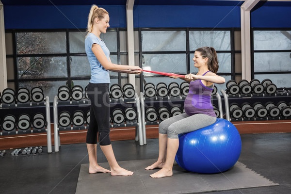 Trainer and pregnant woman using a resistance band Stock photo © wavebreak_media