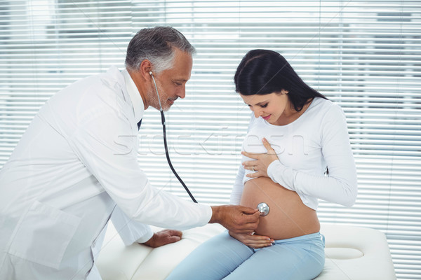 Stock photo: Doctor examining pregnant woman