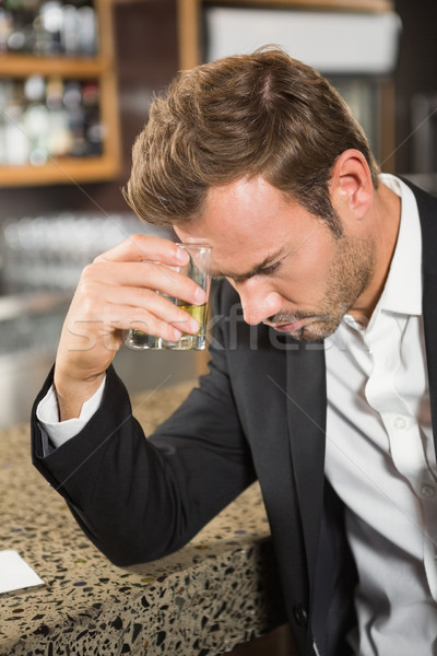 Tired man having a whiskey Stock photo © wavebreak_media