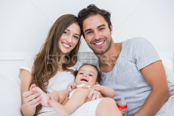 Happy couple with baby relaxing on bed  Stock photo © wavebreak_media