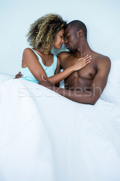 Fiatal pér átkarol szemtől szembe ágy hálószoba szeretet Stock fotó © wavebreak_media