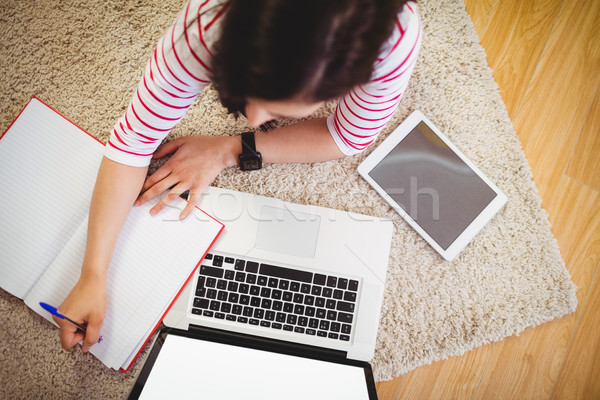 High angle view of woman writing on book Stock photo © wavebreak_media