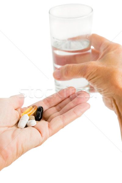 Person holding pills and glass Stock photo © wavebreak_media