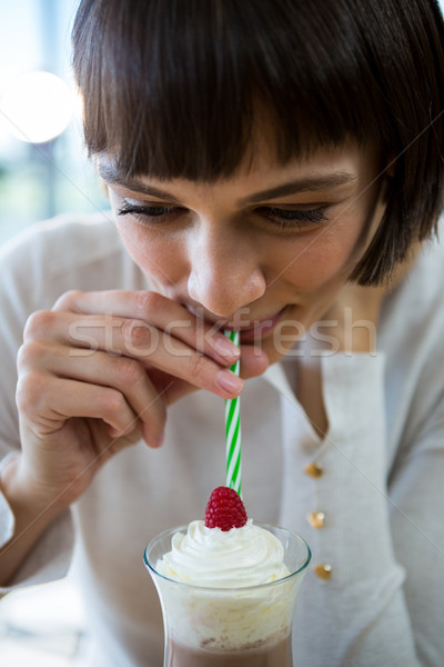 Woman drinking milkshake with a straw Stock photo © wavebreak_media