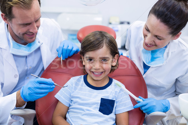 Smiling dentists examining young patient Stock photo © wavebreak_media