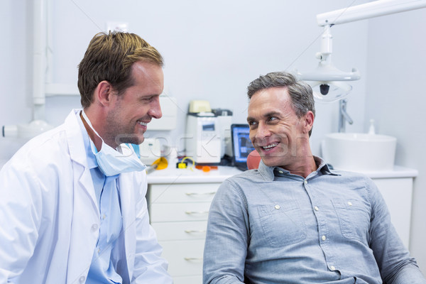 Smiling dentist and patient interacting with each other Stock photo © wavebreak_media
