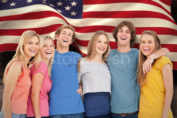 Composite image of a group of friends holding each other and smi Stock photo © wavebreak_media