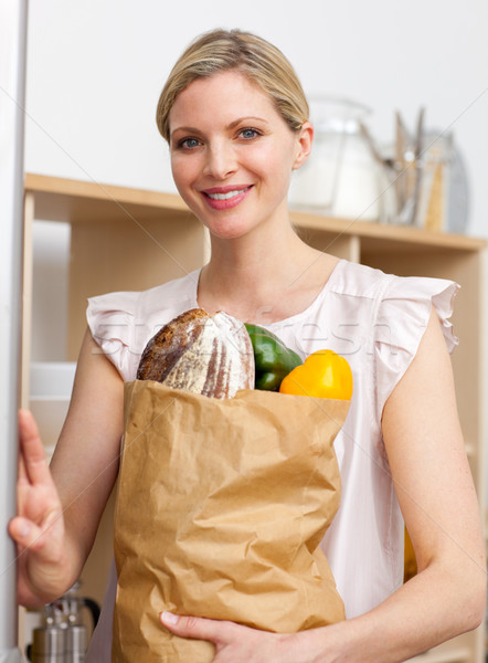 Attractive woman holding a grocery bag Stock photo © wavebreak_media