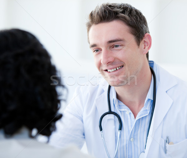 Portrait of a handsome doctor talking with his patient for the a Stock photo © wavebreak_media