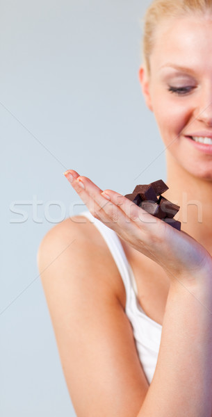 Stock photo: Attractive woman looking at chocolate focus on chocolate 