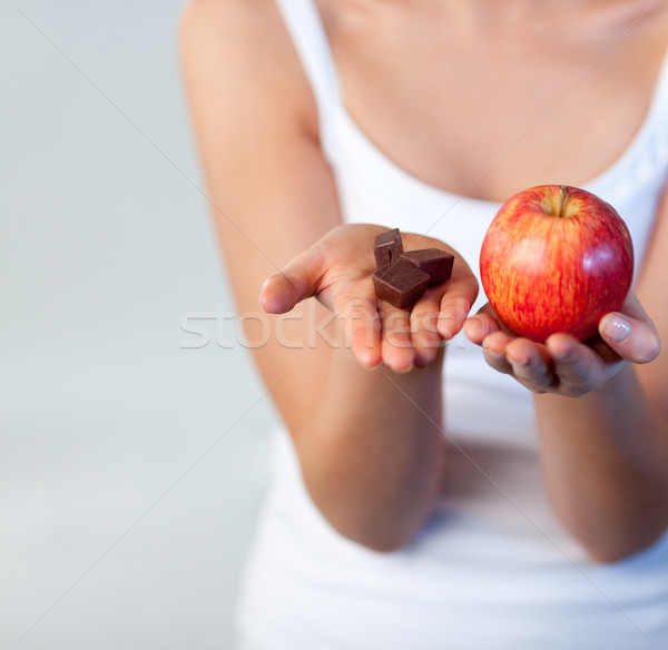 Woman showing chocolate and apple focus on chocolate  Stock photo © wavebreak_media