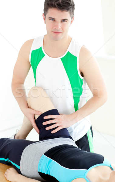 Attractive male physical therapist checking a woman's leg  Stock photo © wavebreak_media
