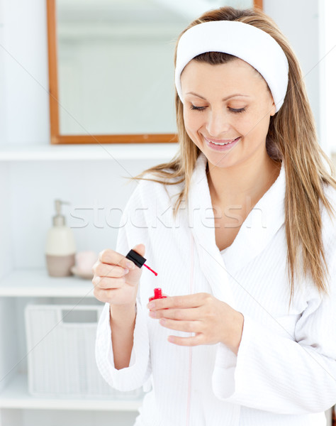 Bright caucasian woman varnishing her fingernails in the bathroom at home Stock photo © wavebreak_media