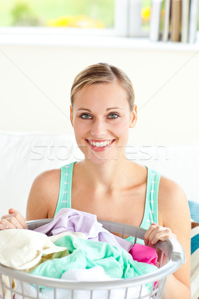 Cheerful young woman doing the laundry at home Stock photo © wavebreak_media