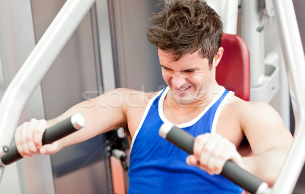Strong athletic man using a bench press in a fitness center Stock photo © wavebreak_media