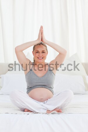 Portrait of a lovely woman stretching her arms in her bedroom Stock photo © wavebreak_media