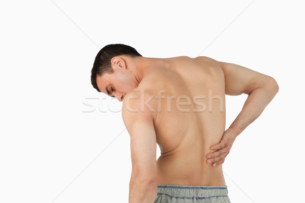 Back view of man suffering from back pain against a white background Stock photo © wavebreak_media