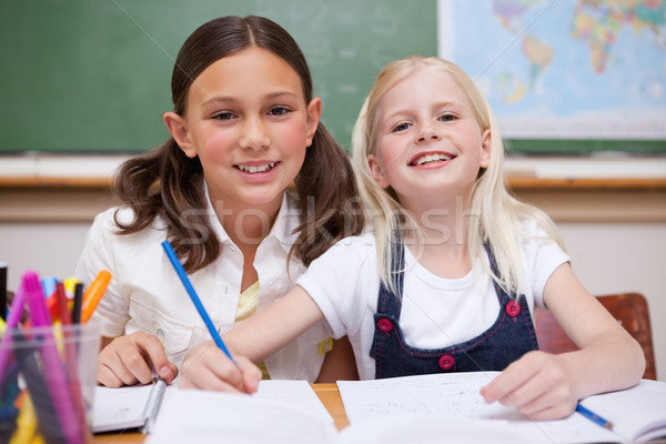Smiling pupils working together on an assignment in a classroom Stock photo © wavebreak_media