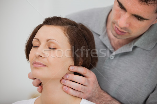 Physiotherapist massaging the neck of a patient in a room Stock photo © wavebreak_media