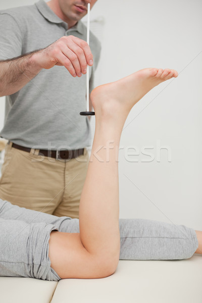 Serious practitioner using a reflex hammer in a medical room Stock photo © wavebreak_media