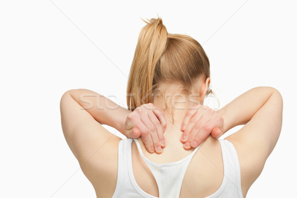 Woman massaging her nape with her hands against white background Stock photo © wavebreak_media