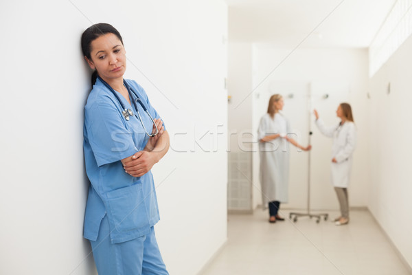 Nurse feeling sad with doctor talking to patient in hospital corridor Stock photo © wavebreak_media