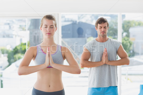 Couple with joined hands and eyes closed in fitness studio Stock photo © wavebreak_media