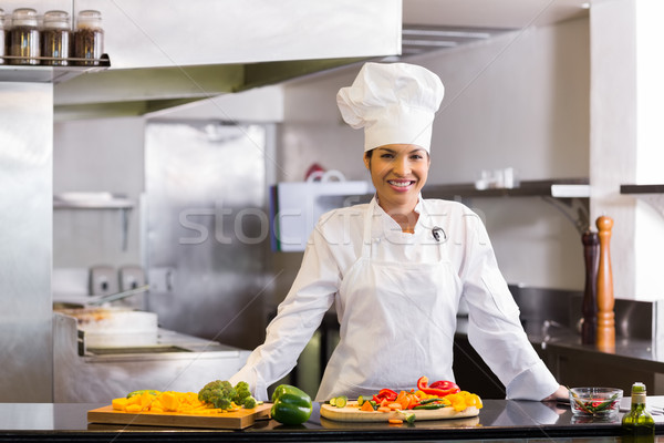 Smiling chef with cut vegetables in kitchen Stock photo © wavebreak_media