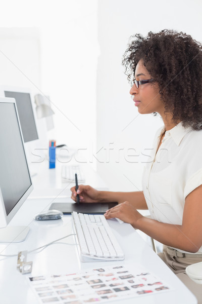 Pretty photo editor using digitizer at desk Stock photo © wavebreak_media