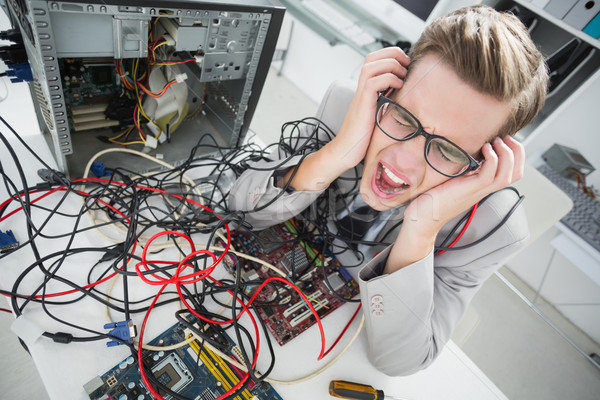 Stressed computer engineer working on broken cables Stock photo © wavebreak_media