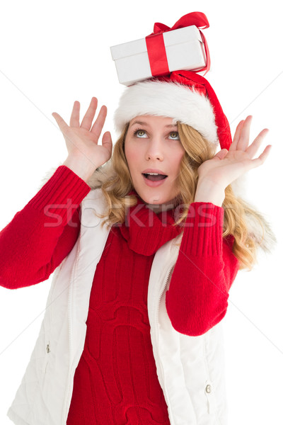 Smiling santa young woman with gift on her head Stock photo © wavebreak_media