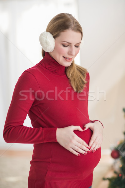 Pregnant woman making a heart with her hands on her belly Stock photo © wavebreak_media