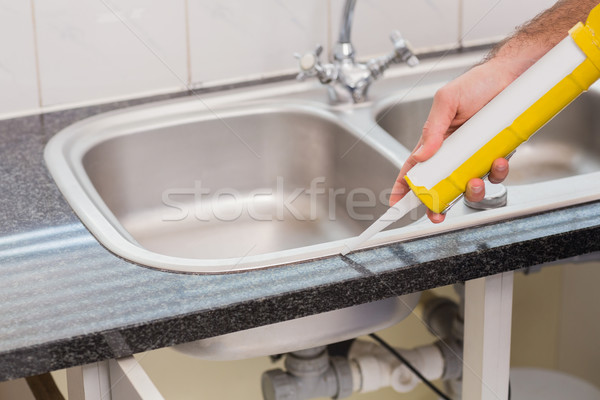 Plumber putting filling in between tiles Stock photo © wavebreak_media