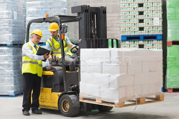 Forklift driver talking with his manager Stock photo © wavebreak_media