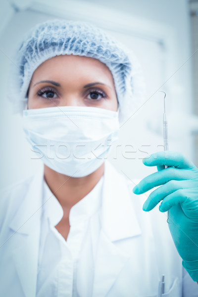 Female dentist in surgical mask holding hook Stock photo © wavebreak_media