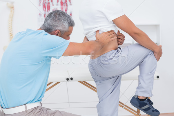 Stock photo: Doctor examining his patient back 