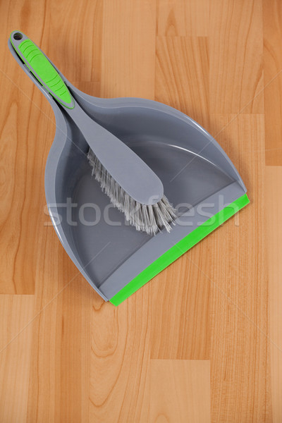 Dustpan And Sweeping Brush On Wooden Floor Stock Photo C Wavebreak