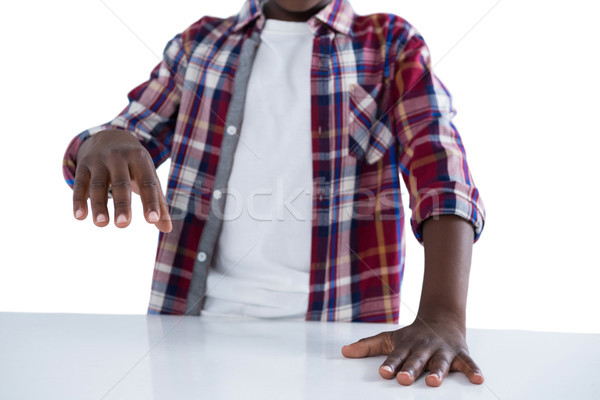 Boy pretending to work on an invisible object against white background Stock photo © wavebreak_media
