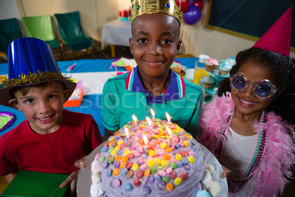 High angle portrait of boy holding birthday cake Stock photo © wavebreak_media