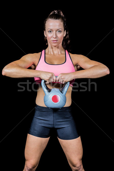 Portrait of confident woman exercising with kettlebell Stock photo © wavebreak_media